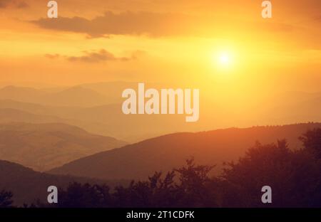Sunset in the foggy autumn Carpatian mountains Stock Photo