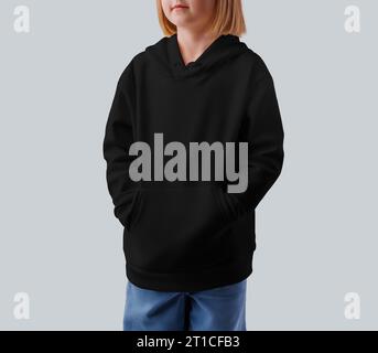 Mockup of a black hoodie for a girl, front view, place for design, print, branding. Casual kid's clothing template, isolated on background. Product ph Stock Photo