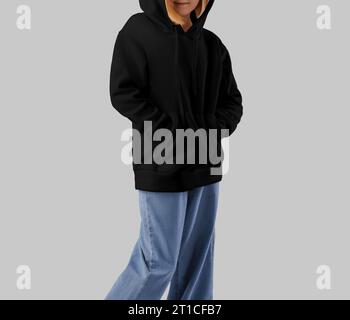 Mockup of a black hoodie for a girl in a hood, for design, branding. Template of stylish kid's clothes, front view, isolated on background. Fashionabl Stock Photo
