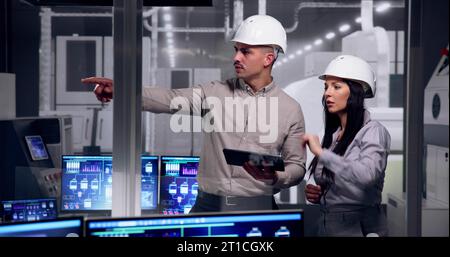 Factory Engineers In Helmets. Checking Industrial Facility Stock Photo