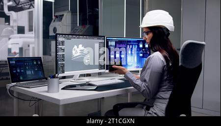 Engineer Doing 3D CAD Model Design On Computer At Factory Stock Photo