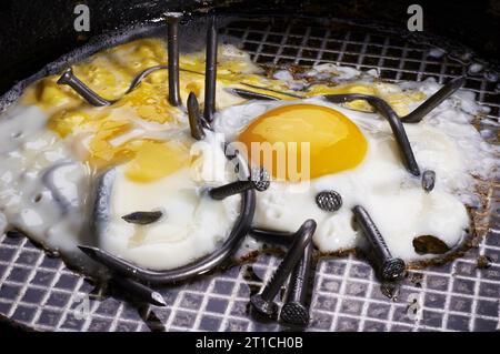 fried eggs with curved nails. conceptual photo. Stock Photo