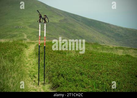 Professional sticks for climbing a mountain on a trail against a blue sky Stock Photo