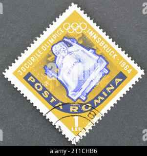 Cancelled postage stamp printed by Romania, that shows Two-men bobsled and promotes winter Olympics in Innsbruck, circa 1963. Stock Photo