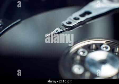 Disassembled hard disc. Read head, magnetic disk and spindle close-up. Stock Photo