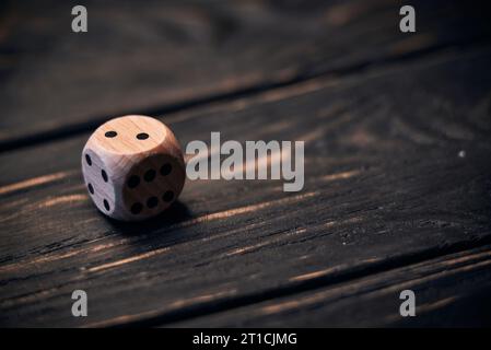 wooden dice on old wood table. number two on the top side Stock Photo