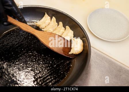 Freshly cooked dumplings gedza with soy sauce. On wooden background. Stock Photo