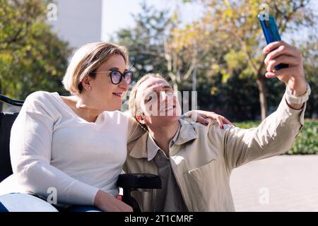 smiling couple taking selfie with mobile phone Stock Photo