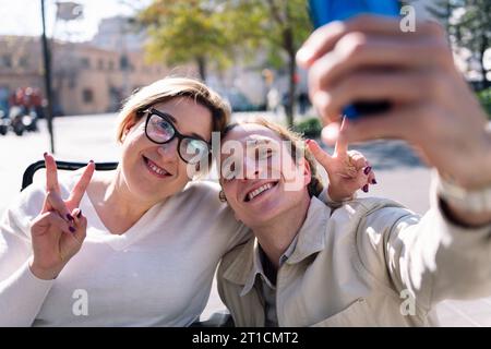 happy couple taking selfie with mobile phone Stock Photo