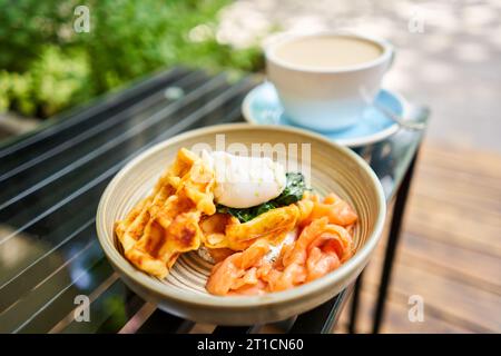 Potato waffles, Poached egg, avocado cream with salmon and egg . Healthy breakfast, protein. Restaurant dish.  Stock Photo