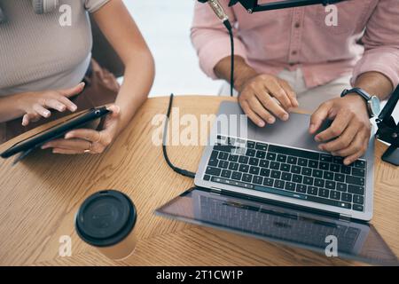 Radio presenter, communication and technology in studio for media company, talking on laptop and tablet. Man, woman or influencer on microphone in Stock Photo