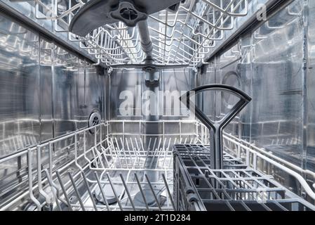 Clean Empty dishwasher machine inside. Stock Photo