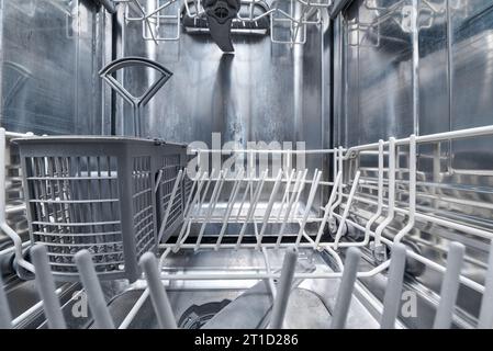 Clean Empty dishwasher machine inside. Stock Photo