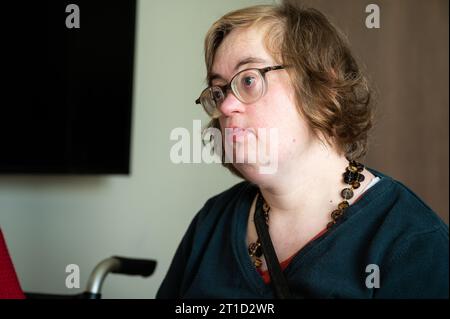 Indoor portrait of a 41 yo white woman with the Down Syndrome, Tienen, Flanders, Belgium Stock Photo