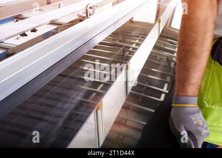 Construction worker cutting ceramic tiles using ceramic cutter Stock Photo