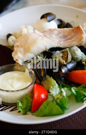 Traditional Provencal Aioli dish served with boiled fish and vegetables, Provence, France. Stock Photo