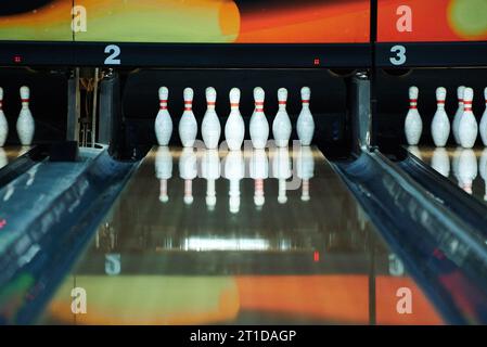 White bowling pins reflecting in bowling alley lane Stock Photo