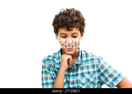 Joyful young individual in a blue plaid shirt chuckles, showcasing a heartwarming smile against a white background Stock Photo