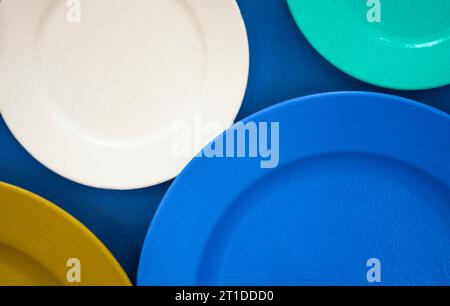 plates of different colors. set colorful cymbals  of different sizes on  background. diversity of tableware and ware. Different sizes, color empty pla Stock Photo