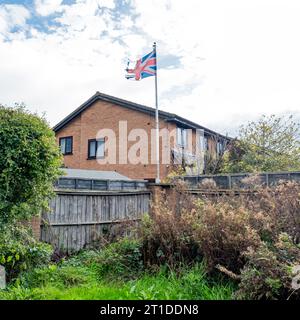 Ripped Union Jack on housing estate UK Stock Photo