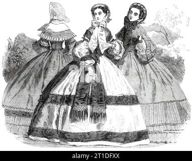 Paris Fashions for October, 1860. '1. Walking Dress...of light green taffety, ample in the skirt...above the flounces there is a narrow edging, likewise of box plaits...The bonnet is composed of velvet and tulle, trimmed with detached flowers, and having round the front edge narrow lace. 2. Dinner Toilet. Slate-coloured silk dress, the skirt trimmed with two purple bands...[with] a series of rosettes, in the centre of each of which is a velvet button...The sleeve consists of a single bouillon...White crape bonnet, trimmed with blonde, the tour-de-tete ornamented with small green leaves. 3. Wal Stock Photo