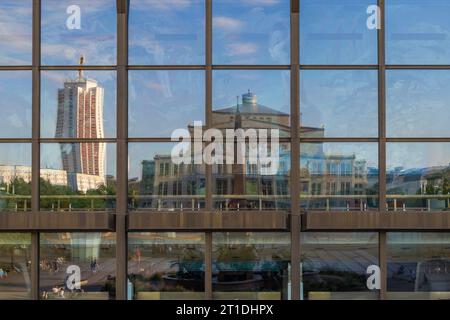 Reflection of Leipzig Opera seen in the glass front of the Gewandhaus building, Leipzig, Saxony, Germany, Europe Stock Photo