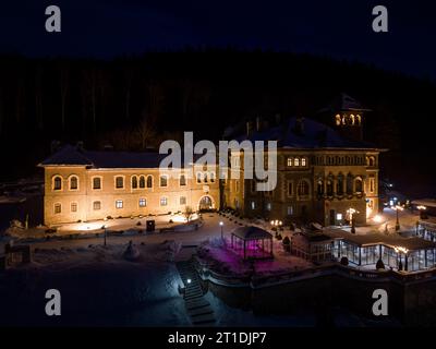 Aerial view of Cantacuzino Castle in winter at night. Busteni, Romania. Stock Photo