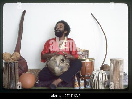 A 1983 posed portrait of Nana Vasconcelos, Brazilian jazz percussionist, playing the dondo ...
