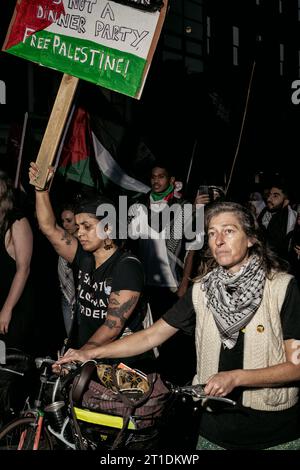 Dublin, Ireland. 9th Oct, 2023. An activist holds a placard during the demonstration. Two days of demonstrations have taken place in Dublin by members of the Palestinian community as well as supporters from various diaspora and by locals and activist groups in a show of solidarity in light of recent strikes on Gaza by Israeli military forces. Protestors gathered in Dublin City centre, at government buildings and marched to the Israeli Embassy where speeches were made by members of the Palestinian community, students, activists and members of Irish political socialist party People Before Prof Stock Photo