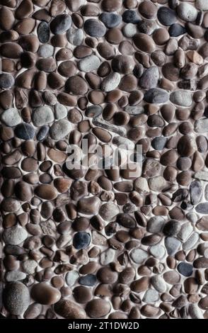 Sea pebbles. Pebble background. Multi-colored pebbles. Wall decor. Stock Photo
