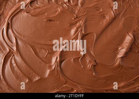 Brown background with cocoa cream spread texture detail. Top view. Stock Photo