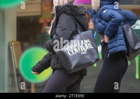 Versace Jeans Couture in Preston, Lancashire.  UK Weather. 13 Oct 2023 Rainy start to the day in Preston. Credit; MediaWorldImages/AlamyLiveNews Stock Photo