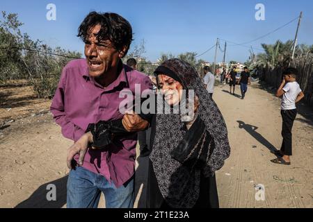 Rafah, Palestinian Territories. 13th Oct, 2023. An injured woman is carried away following an Israeli bombing in the Rafah refugee camp in the southern Gaza Strip as fighting between Israeli troops and Islamist Hamas terrorists continues. Credit: Abed Rahim Khatib/dpa - ATTENTION: graphic content/dpa/Alamy Live News Stock Photo