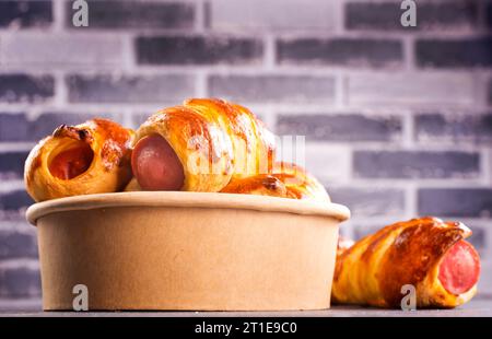 An uncooked sausage bread roll or hotdog bun dough Stock Photo