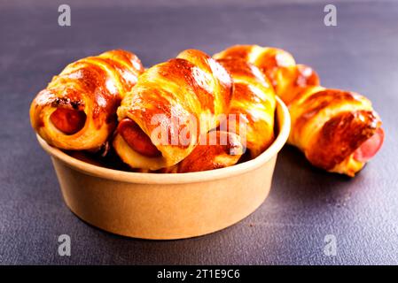 An uncooked sausage bread roll or hotdog bun dough Stock Photo