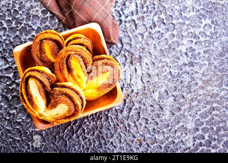 Freshly baked cinnamon rolls in wooden bowl Stock Photo