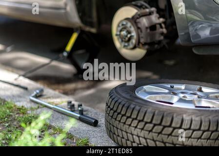 changing the tires of a car from  winter tires to summer tires in spring Stock Photo