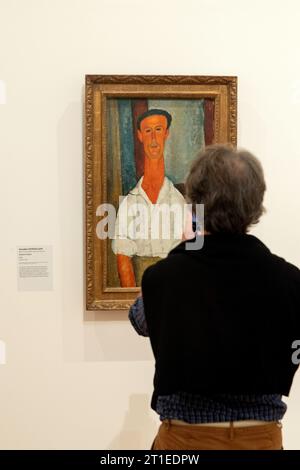 Ceret (south of France): the Modern Art Museum. Man in front of the work by Amedeo Modigliani “Gaston Maudotl”, 1918, on the occasion of the exhibitio Stock Photo
