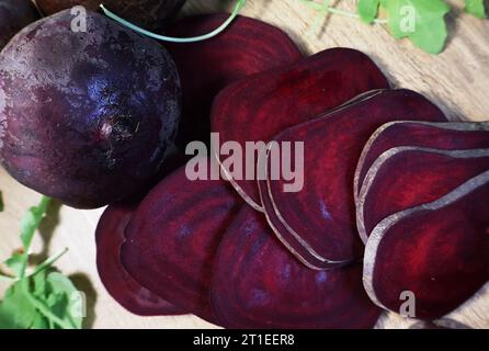 fresh beetroots on the wooden table. Sliced beet and the leaves Stock Photo