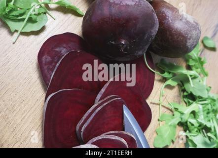 fresh beetroots on the wooden table. Sliced beet and the leaves Stock Photo
