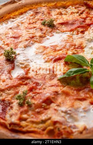 Thin pizza base with tomato sauce and soft cheese Stock Photo