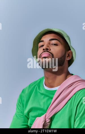 portrait of bearded stylish man with diamond earring in panama looking at camera, fashion concept Stock Photo