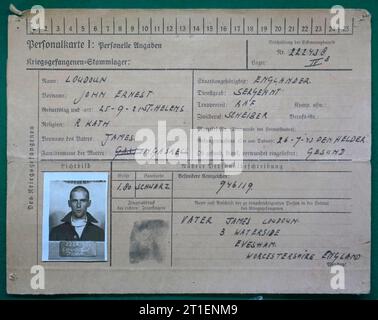 Unusual German prisoner of war record card or 'personalkarte' for British prisoner, and RAF sergeant captured in 1943.  Filled in with prisoner's name and details, along with a passport type black and white photograph and thumb print. Also contact for next of kin in England. Stock Photo