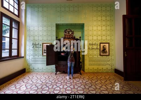 Medellin, Colombia - January 10, 2023: Visitor checks a closet in one of the rooms of the Rafael Uribe Cultural Palace. On the wall it is written 'Raf Stock Photo