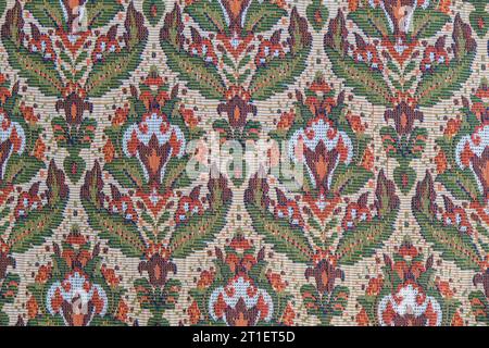 Close up abstract vintage brown red green ethnic background. Stock Photo