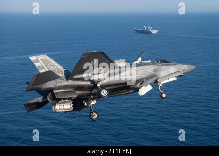 An F-35B Lightning II fighter aircraft to the U.K. HMS Prince of Wales aircraft carrier in the Western Atlantic Oct. 11, 2023. Photo by Dane Wiedmann Stock Photo