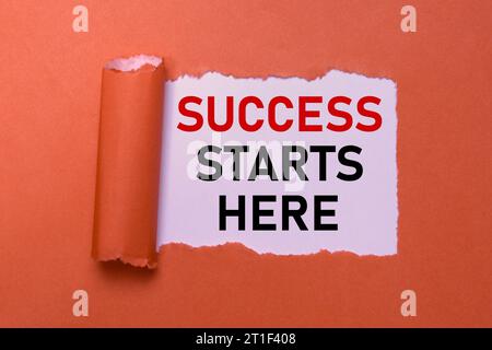 Success Starts Here Symbol. Inspirational Words on Red Torn Paper. Motivational Concept for Business Success with Copy Space. Stock Photo