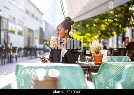 Portrait of a mature businesswoman sitting in an outdoor cafe Stock Photo