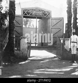 General Kitchener and the Anglo-egyptian Nile Campaign, 1898 The entrance to Wadi Halfa prison, where Emir Mahmoud, leader of the Sudanese (Dervish) forces, was held after defeat at the Battle of Atbara. The open gate is guarded by a Sudanese sentry and prisoners are visible in the courtyard beyond. Photograph was probably taken on the day of the departure of 21st Lancers, when prisoners were used as porters to convey the Regiment's luggage to the train. Stock Photo