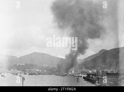 HMS Thistle, 1st Class Gunboat at the China Station 1910 - 1912 Timber yard on fire outside RN Dockyard Hankow. Stock Photo